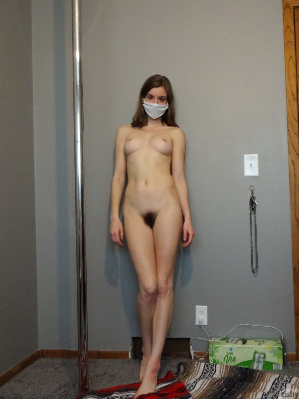 Голая девушка в маске дома на карантине - фото