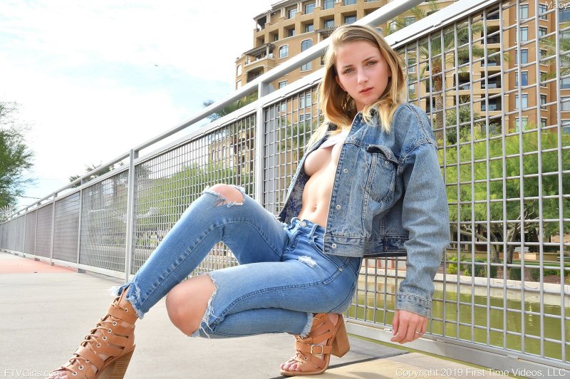 Девушка в джинсах светит сиськи на улице - фото